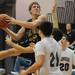 Dexter senior Jay Lewis looks to shoot the ball over Pioneer defenders during the second half against Pioneer during a district match up at Pioneer on Wednesday. Melanie Maxwell I AnnArbor.com